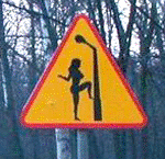 road caution sign - decorated lamp posts? the woods are full of hookers? men driving erratically?